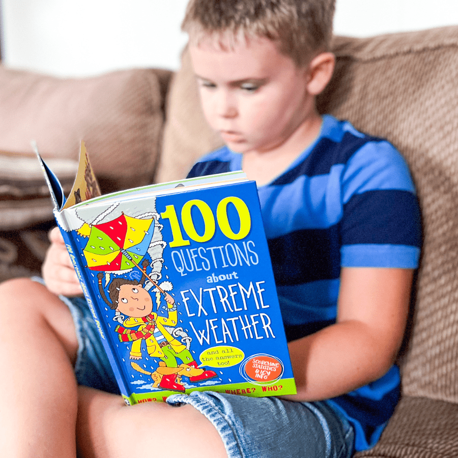 Child reading a book for weather unit study for elementary homeschool