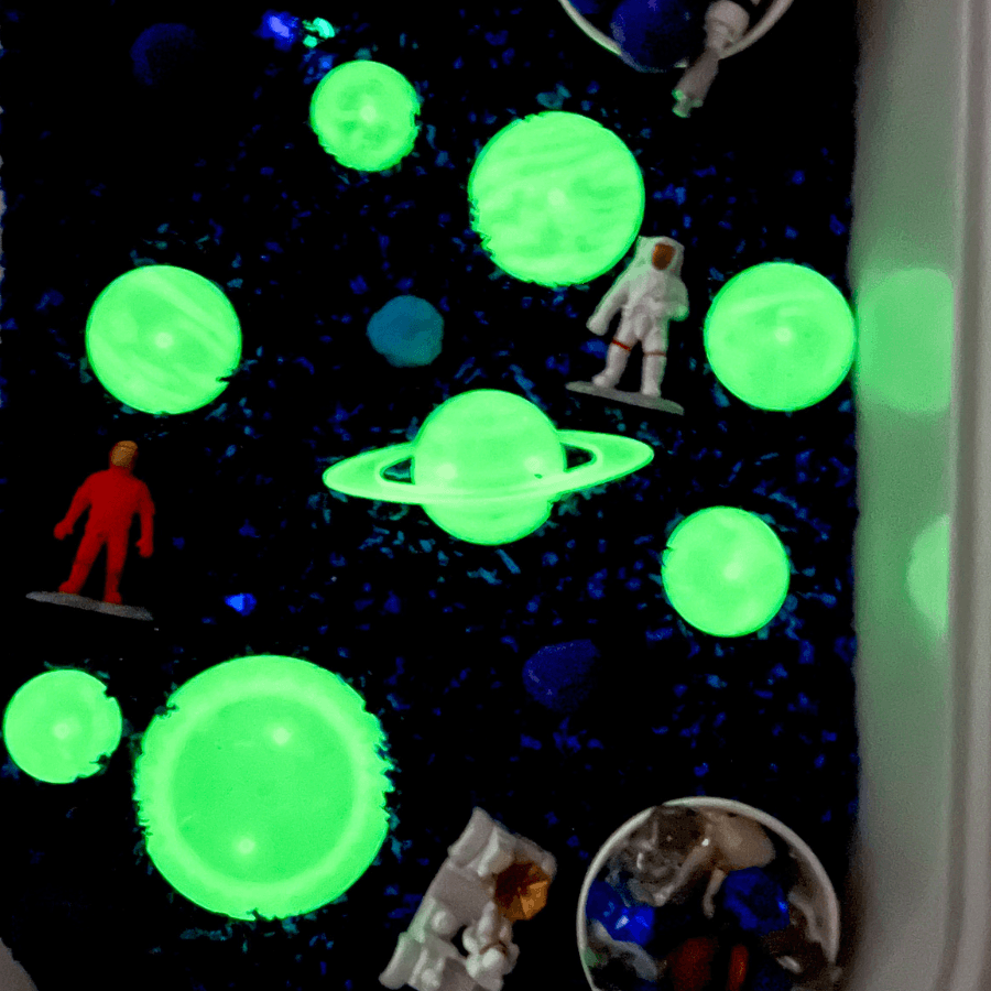 Sensory play bin with Playfoam, glow-in-the-dark planets, and Safari LTD Space TOOB.